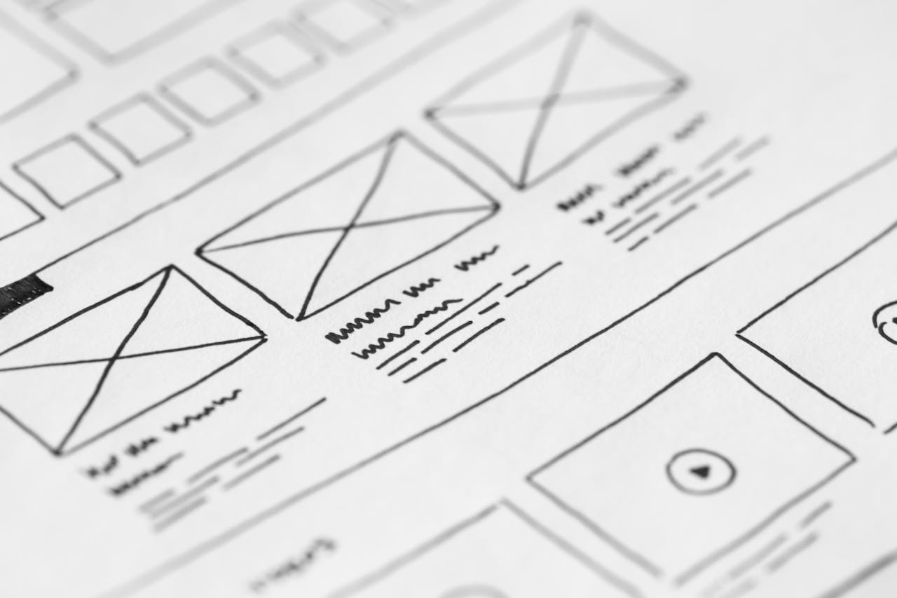 services-03 Detailed close-up of a hand-drawn wireframe design on paper for a UX project.